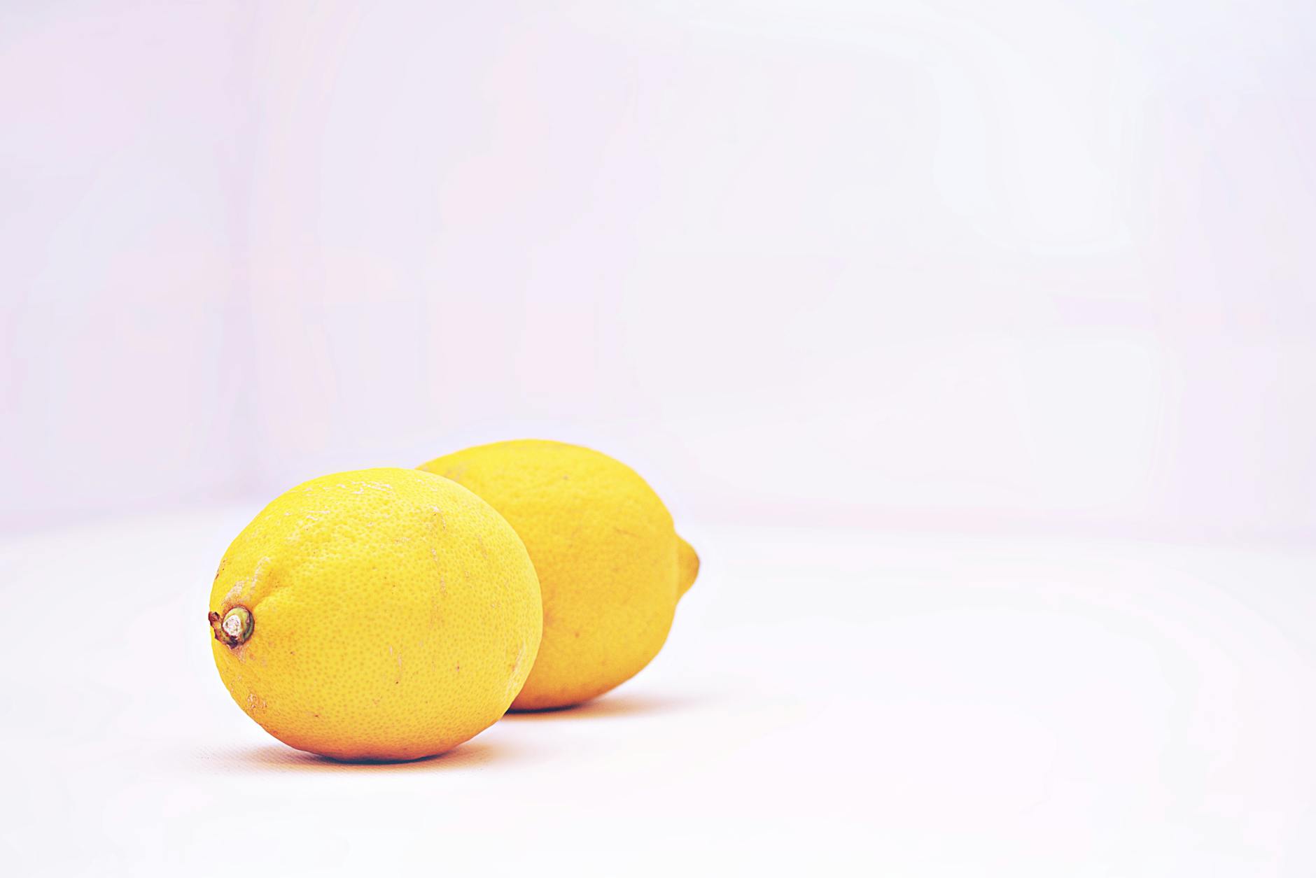 Two vibrant lemons on a white background, symbolizing gentle reawakening and natural sensation recovery