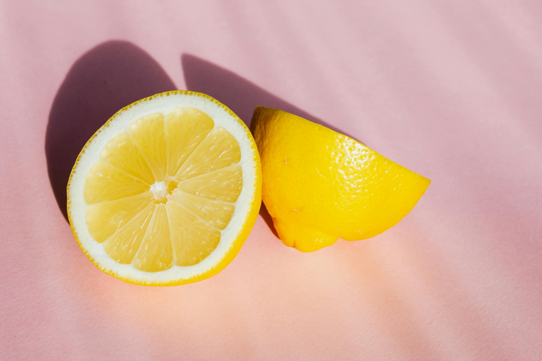 Teal lemon vibrator on white silk fabric, symbolizing sensuality and self-care