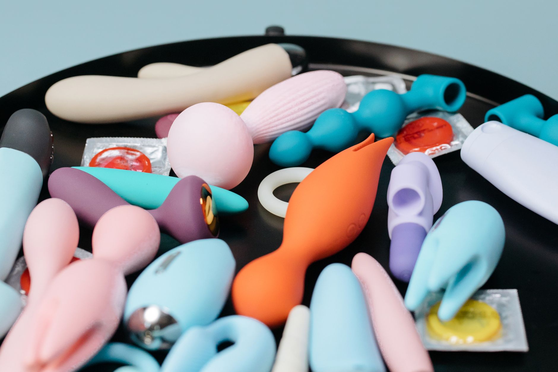 A collection of colorful lemon vibrators and other adult toys on display