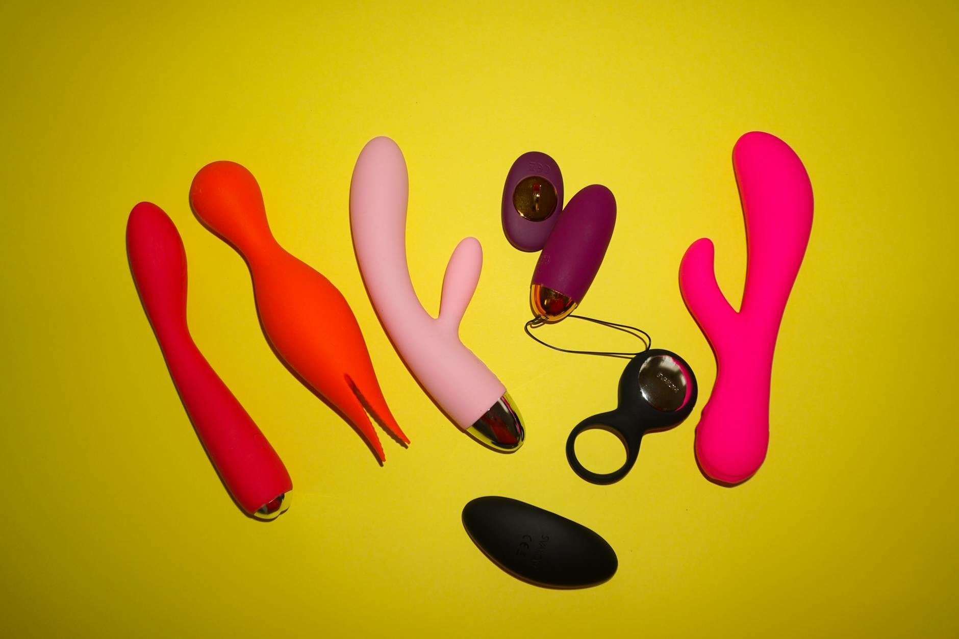 Colorful lemon vibrators and clitoral toys arranged on a bright background
